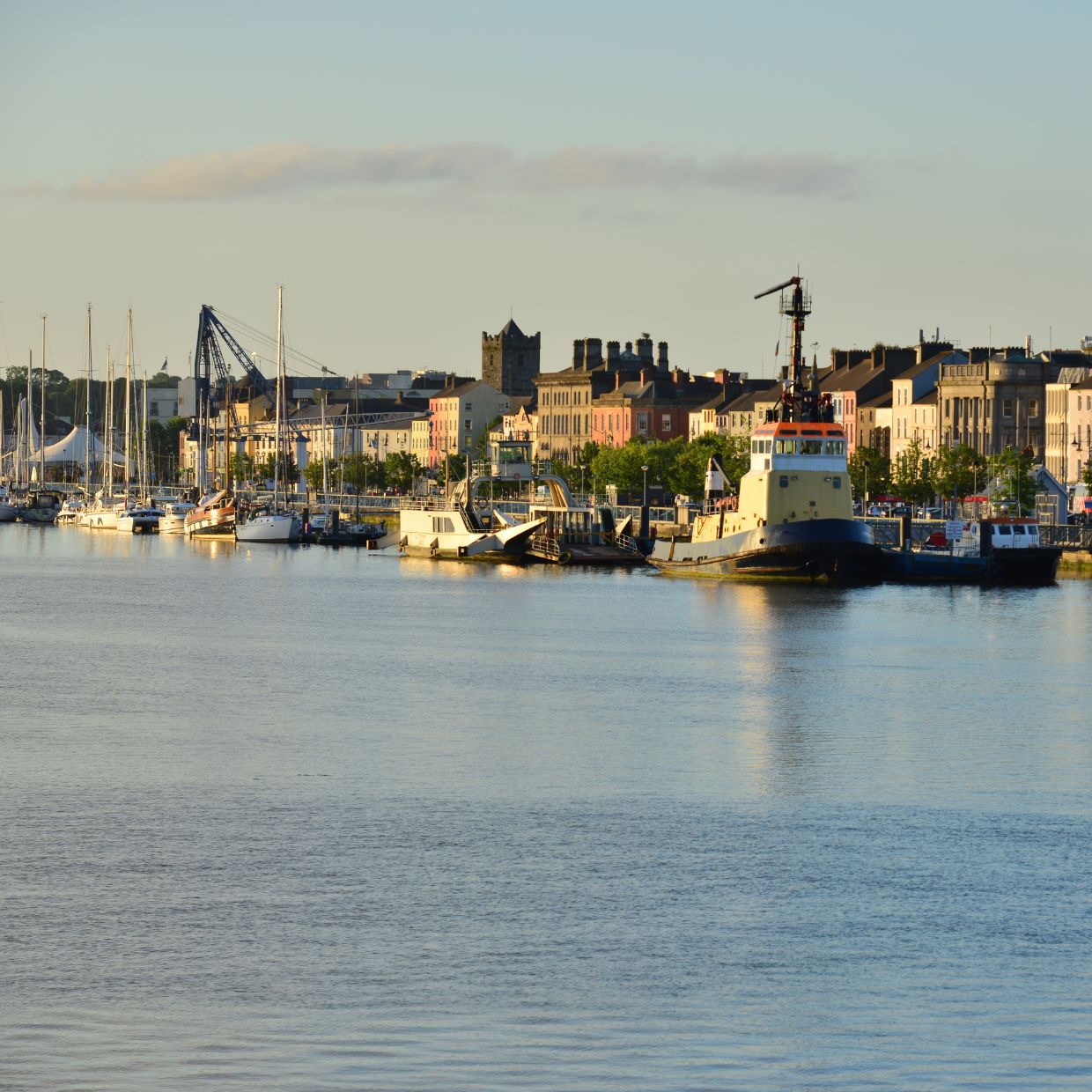 Boats and colorful buildings along the waterfront in Waterford, Ireland’s oldest city